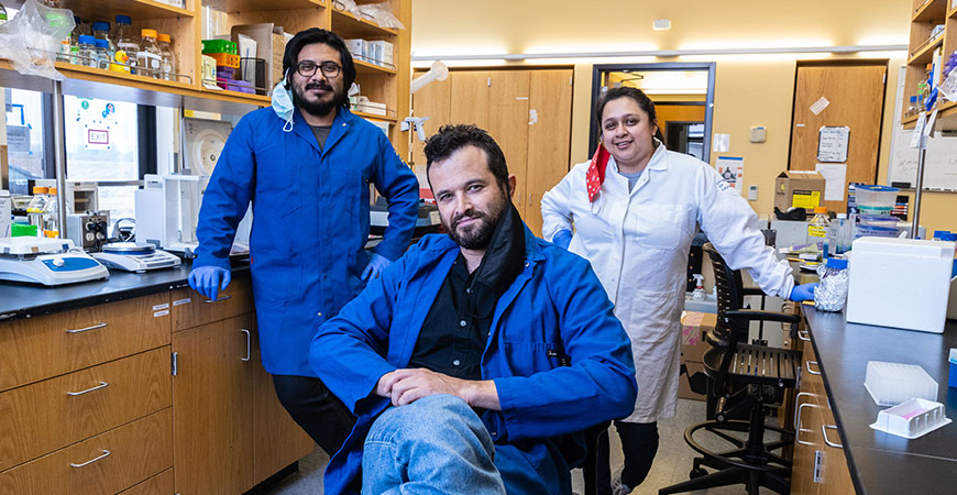 Professor Shahar Sukenik, center, with graduate students Eduardo Flores and Karina Guadalupe, investigate intrinsically disordered proteins.