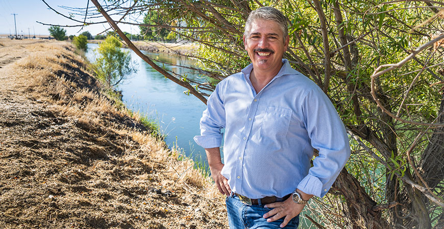 Professor Joshua Viers stands near a canal on the UC Merced campus.